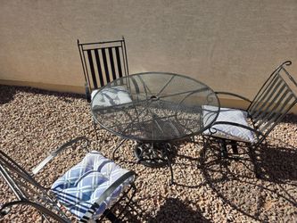 Patio table, 3 chairs and umbrella stand.