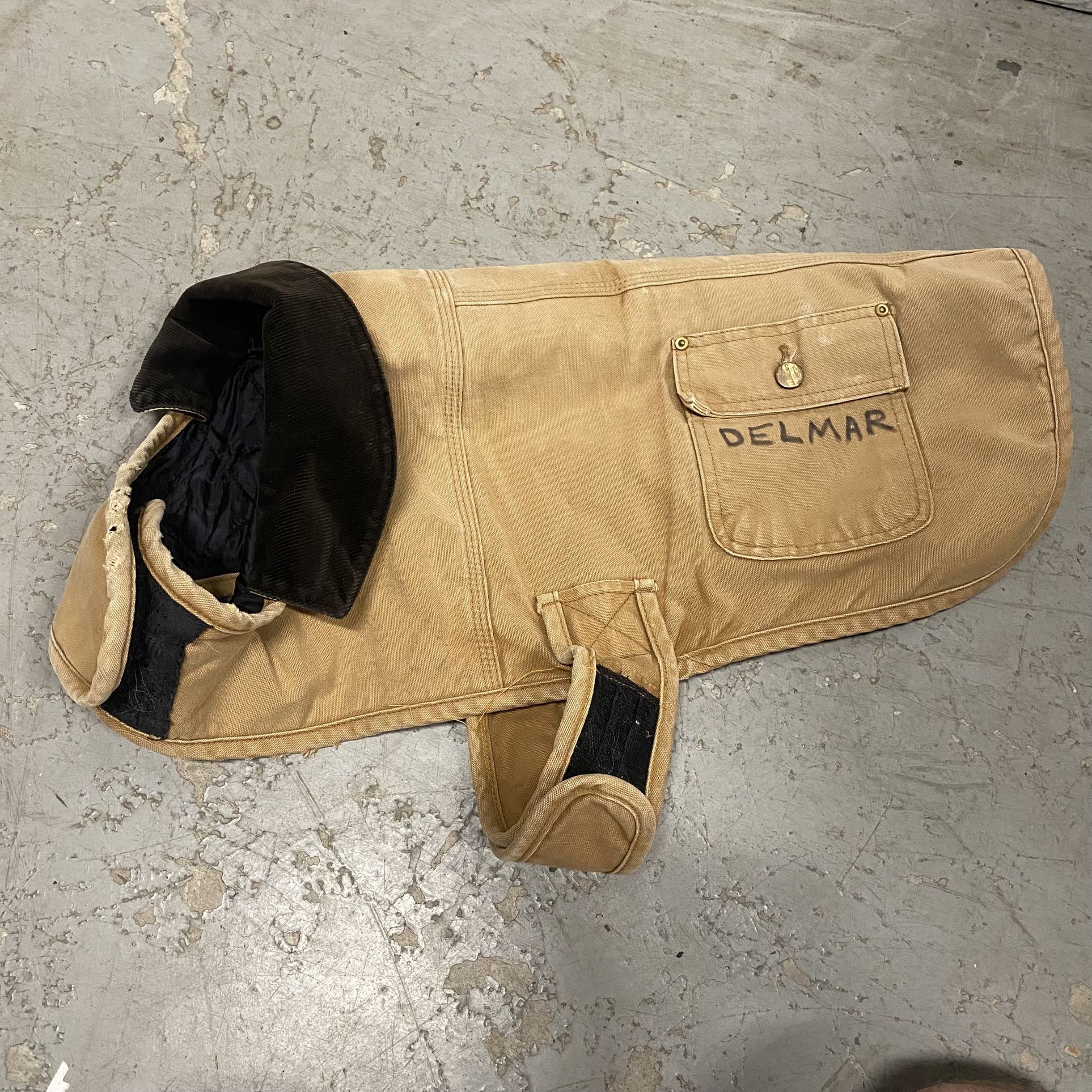 Khaki Tan CARHARTT Dog Chore Jacket Coat with Corduroy Collar, Pockets, and Black Lining. Good pre-owned condition. DELMAR is written on the jacket.