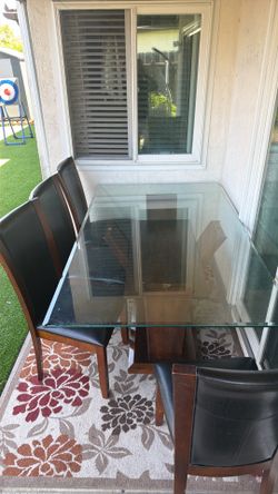 Glass top dining table with six chairs