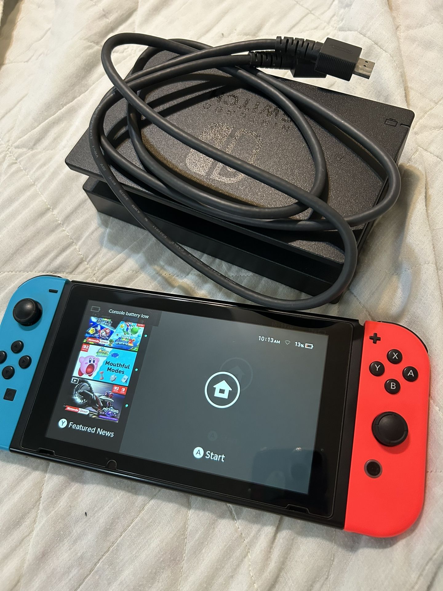 Nintendo Switch Console with red blue Joycons and dock