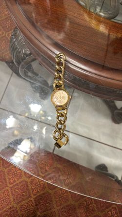 Express FMDEX1458 women's quartz watch with a gold-toned stainless steel band