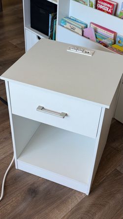White bedside table with receptacles