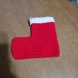 Handmade crochet Christmas stocking in red with a white cuff. 