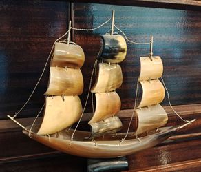 Vintage carved horned sail boat