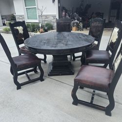 Grand Hacienda 60' Pedestal Table And 6 Cow Hide Chairs . Bought New For $3500.00