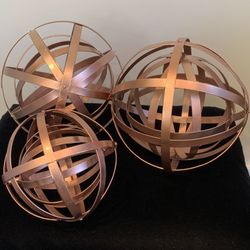 Three Metallic Copper-Colored Orbs