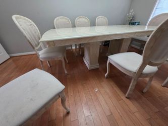 Dining table with 10 chairs. Moderately used.