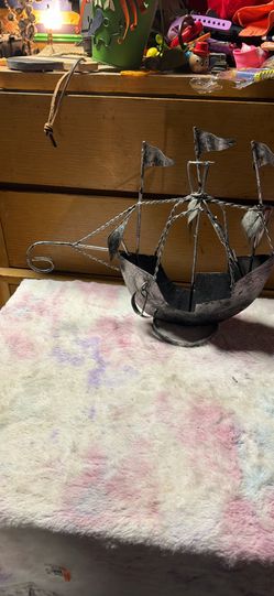 This item is a collectible vintage rustic metal pirate ship sculpture often used for nautical home decor. Key specifications