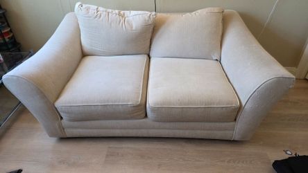 Cozy couch with some cat scratches