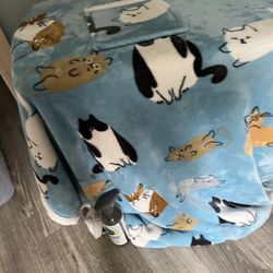 A Snuggle Blanket With Arms And A Front Pocket