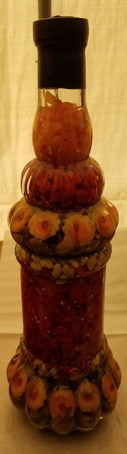 Large bottle of preserved peppers NOT for human consumption.