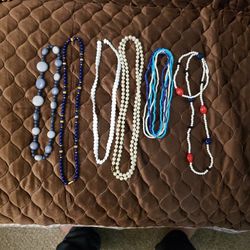 6 necklaces of beads, some of which are precious stones