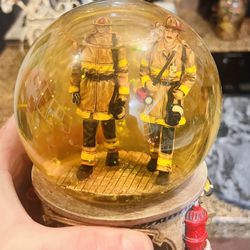 vintage musical snow globe featuring a firefighter theme.