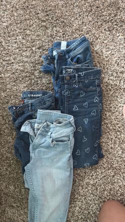 Four pairs of girl jeans