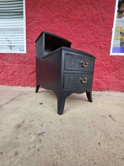 Vintage telephone table, top veneer is loose on one side, has a black matte finish, very solid wood structure and bones are extremely soumd throughout