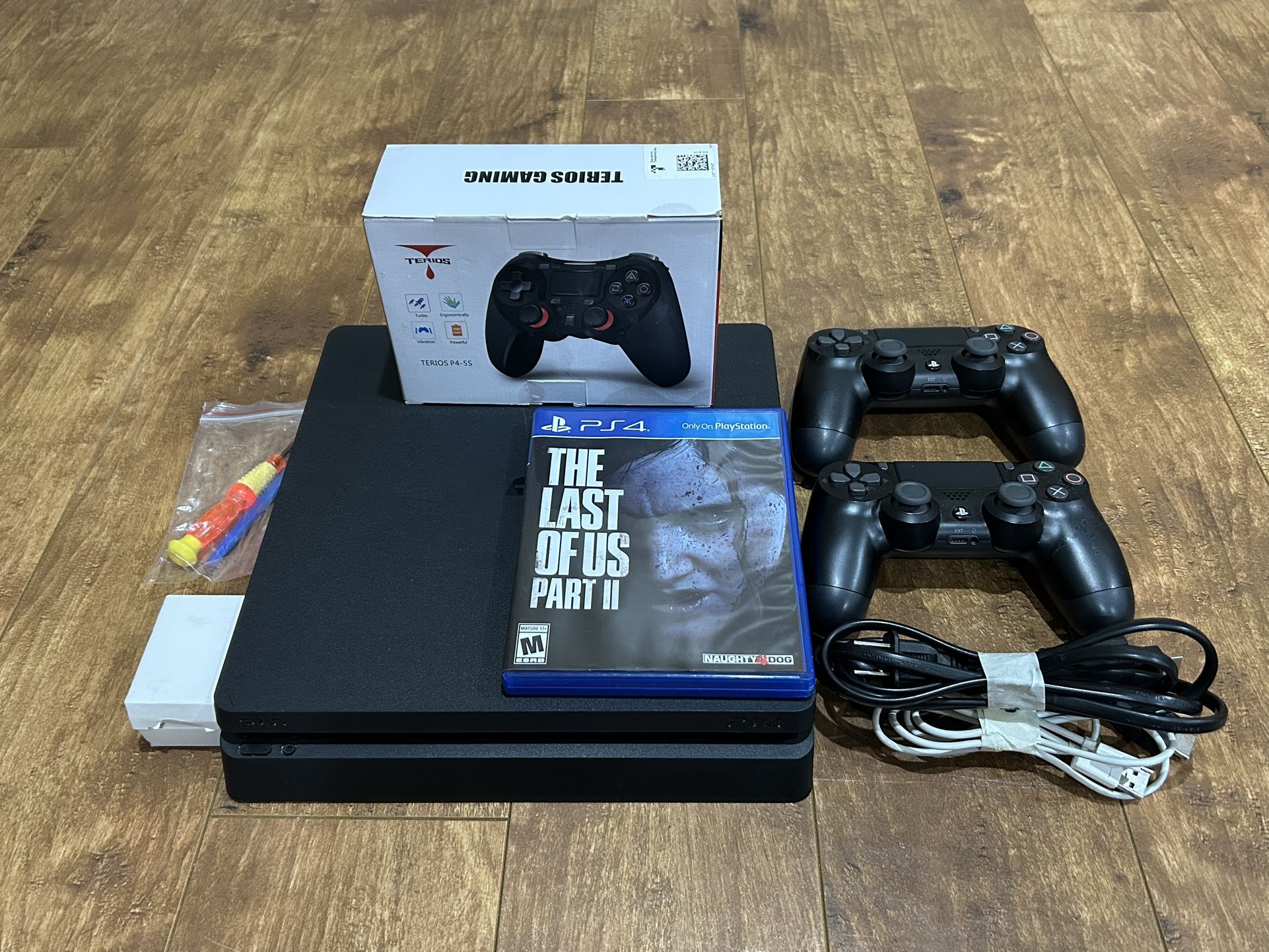 PS4 Console Bundle Lot, Ready to Play! 2 Dual Shock Controllers, Included TLOU Game & Cables + More