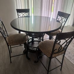 Signature Design by Ashley 5-piece brown countertop height dining table plus the  glass top is included. 