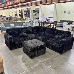 Black jumbo corduroy sectional sofa with ottoman