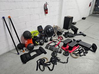 Large lot of used fitness equipment including kettlebells, medicine balls, a TRX slam ball, BOSU ball, resistance bands, gymnastic rings with straps, 
