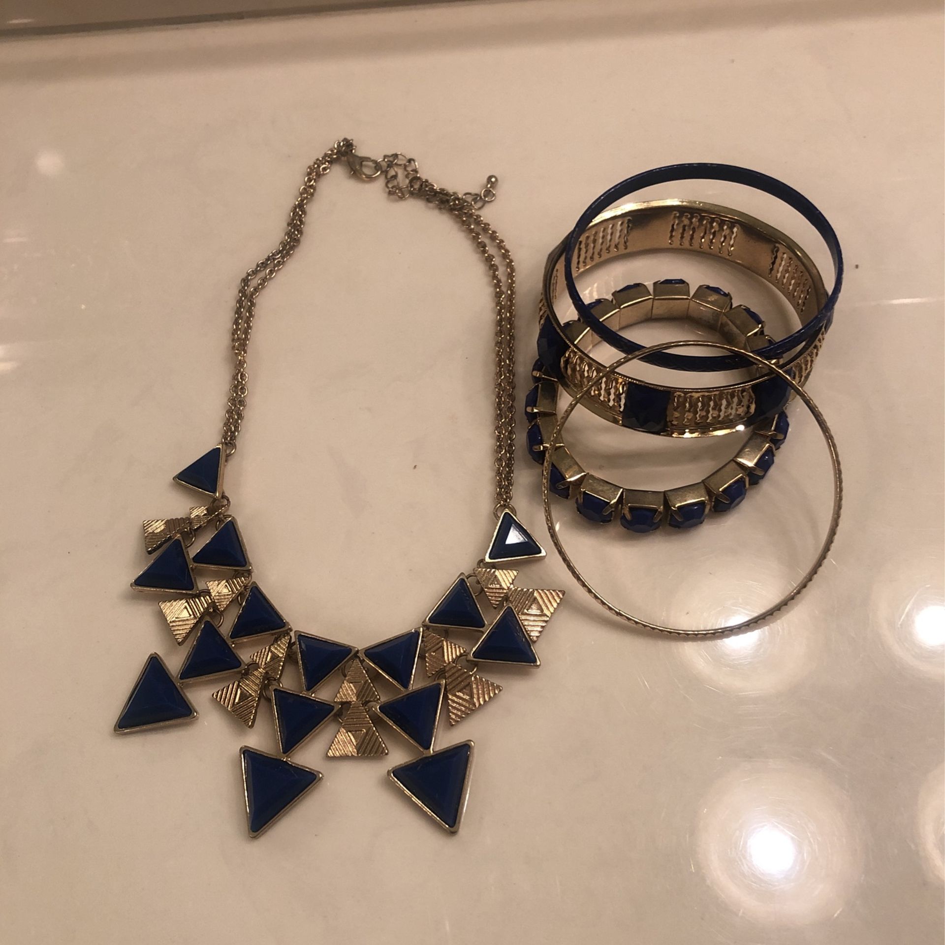 Gold tone and blue choker necklace with four matching bracelets