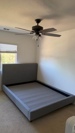Gray Queen size bed with wooden legs