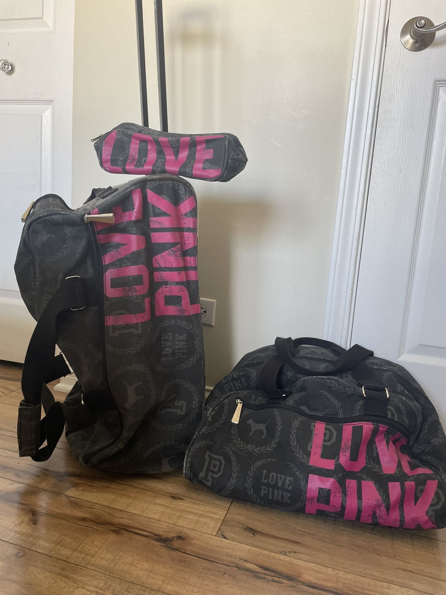 Pink Victoria’s Secret 3 piece rolling luggage set.