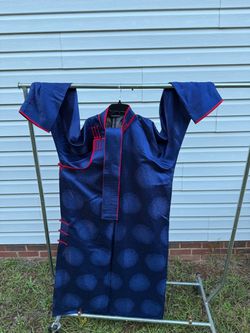 dark blue patterned long tunic or robe—resembling a traditional Mongolian Deel or Asian-style ethnic coat—featuring a round patterned design, contrast
