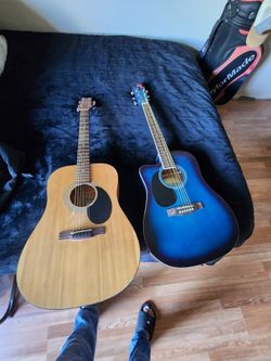 2 nice guitars blue one is a left handed and the other is right handed