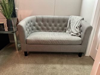 Gray tuffed mini couch