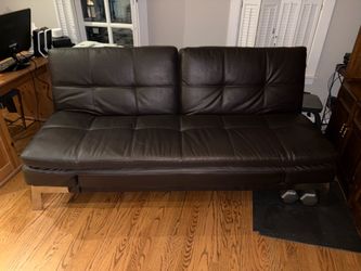 NEW LEATHER COUCH NEVER USED - FOLDS INTO BED