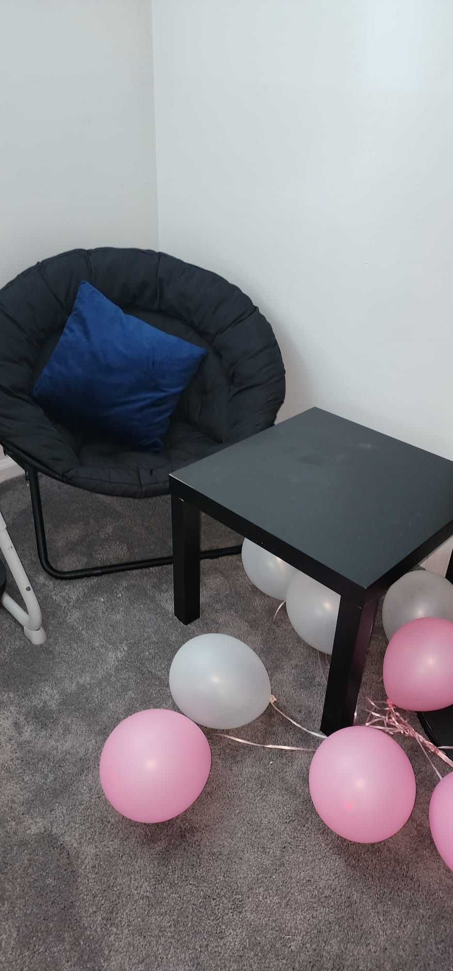 Black dish chair and IKEA coffee table