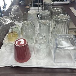 Assortment of flower vases and two wine glasses