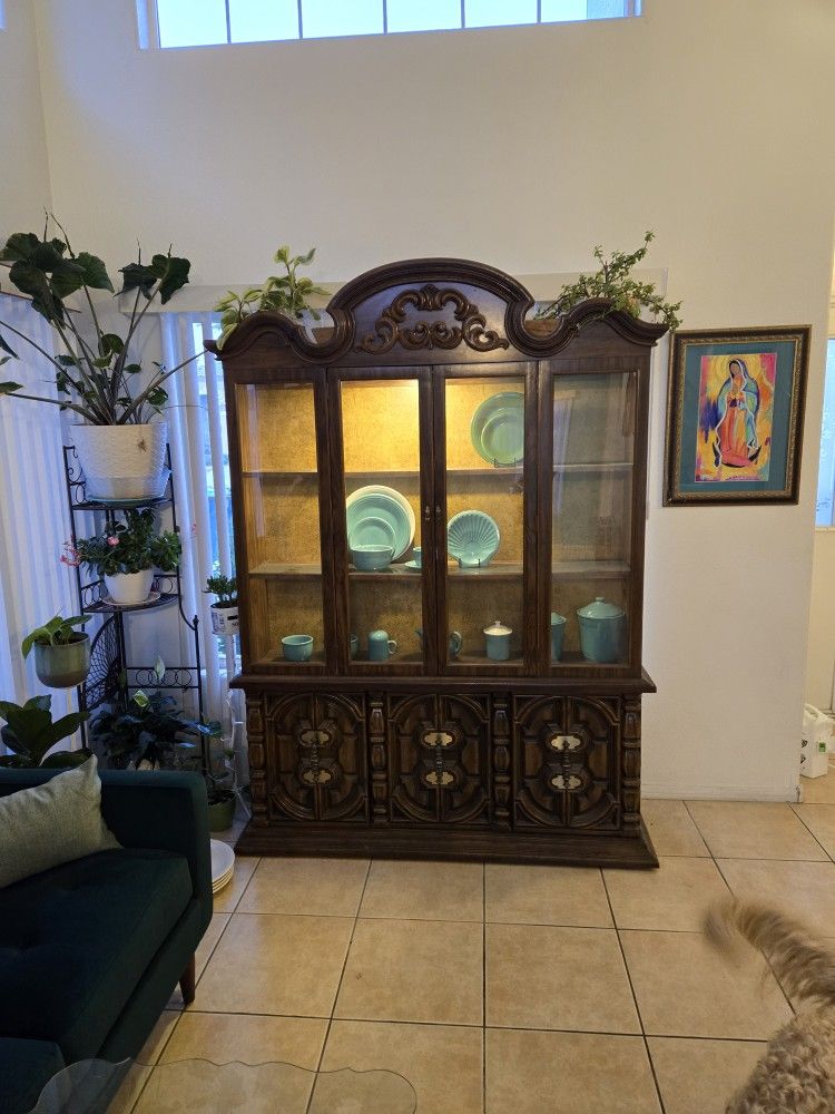 China cabinet with glass shelves and light inside