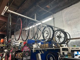 Bicycle wheel and frame storage racks