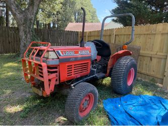Kubota L2050 compact utility tractor, recognizable by its orange body, "L2050" branding, and black front grill guard.