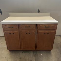 Three Wooden Cabinets With Countertop