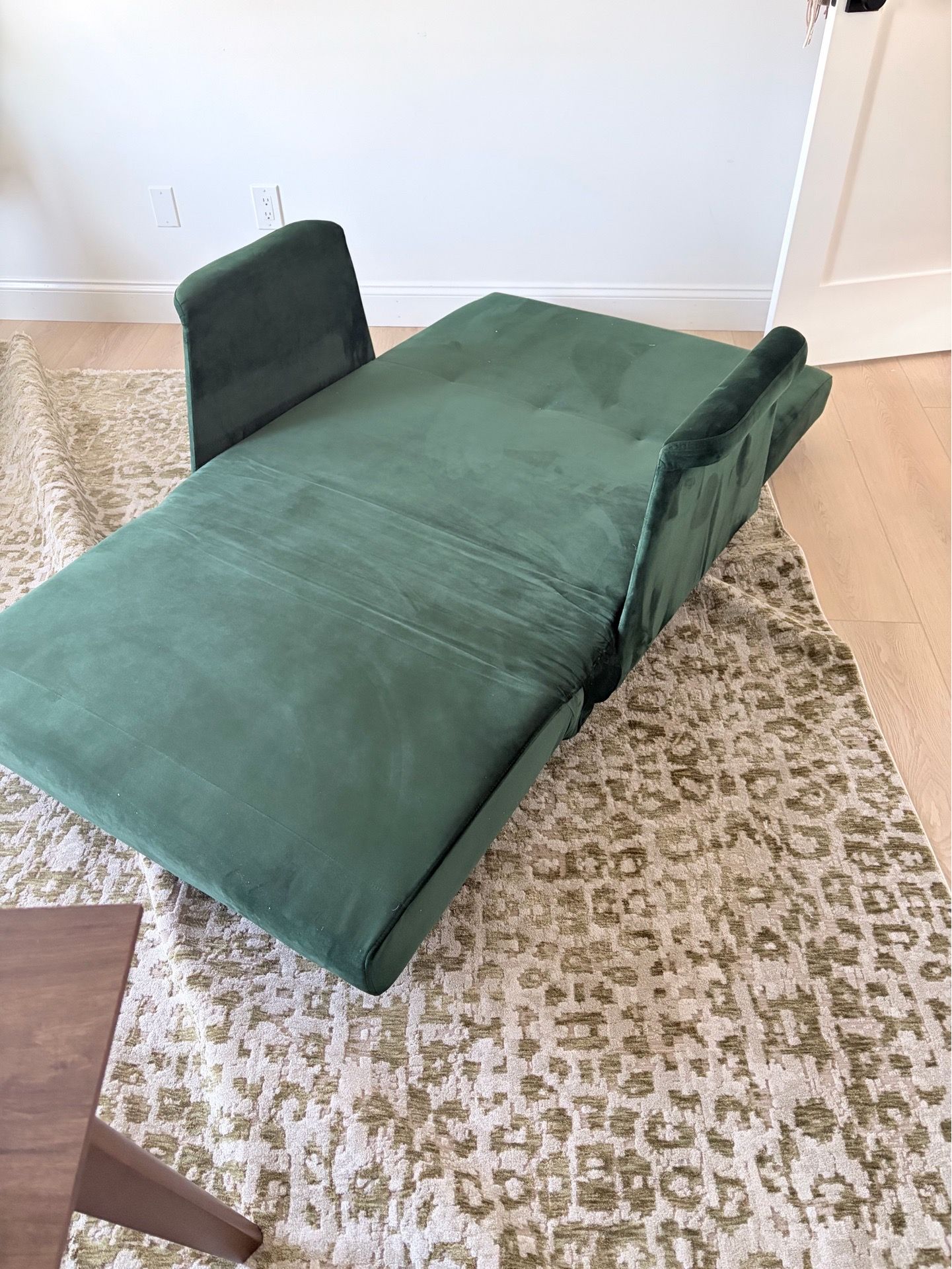Green velvet accent chair converts to bed