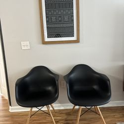 Two arm chairs in black + natural wood