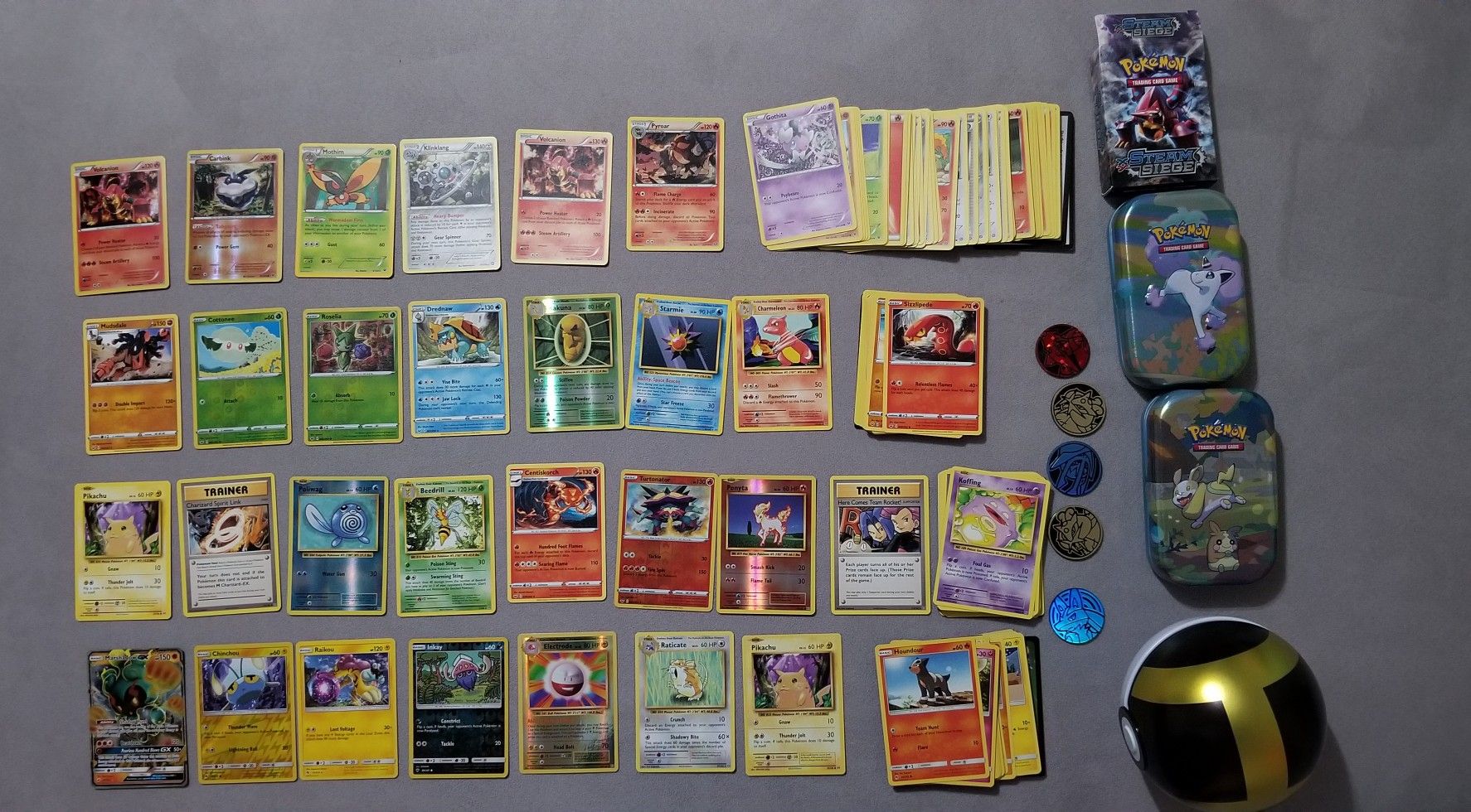 Pokemon tins, ball, and cards. Two Pikachu, Marshadow GX, Rare holo.