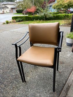 2 Tan Leather stackable Chairs