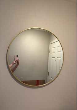 Circular golden wall mirror