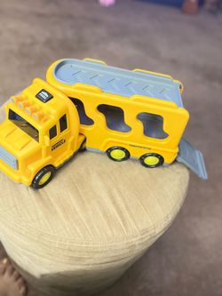 Yellow truck for transporting construction vehicles