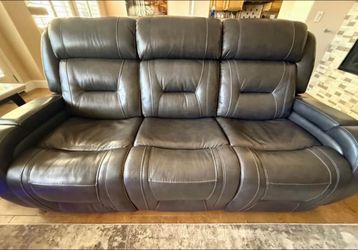 Charcoal Leather Reclining Sofa and Loveseat with us charging and blue floor lights