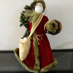 Santa In Red Trimmed In Fur Carring a Bag