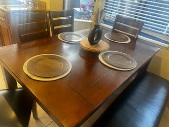 Kitchen table with four chairs and bench