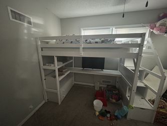 white wooden loft bed with built in desk/dressers