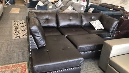 Brand new reversible sectional with ottoman - black faux leather