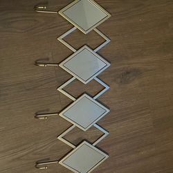 Gold mirror with hooks