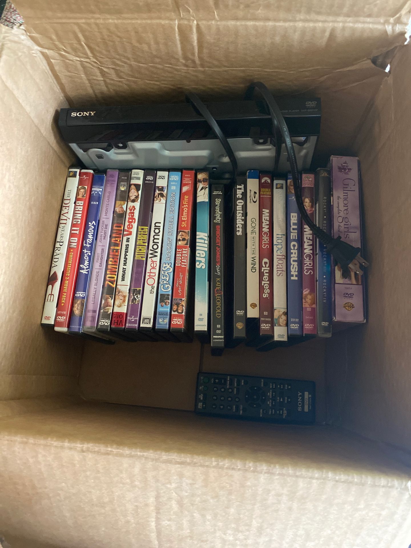 DVD player and box of DVDs
