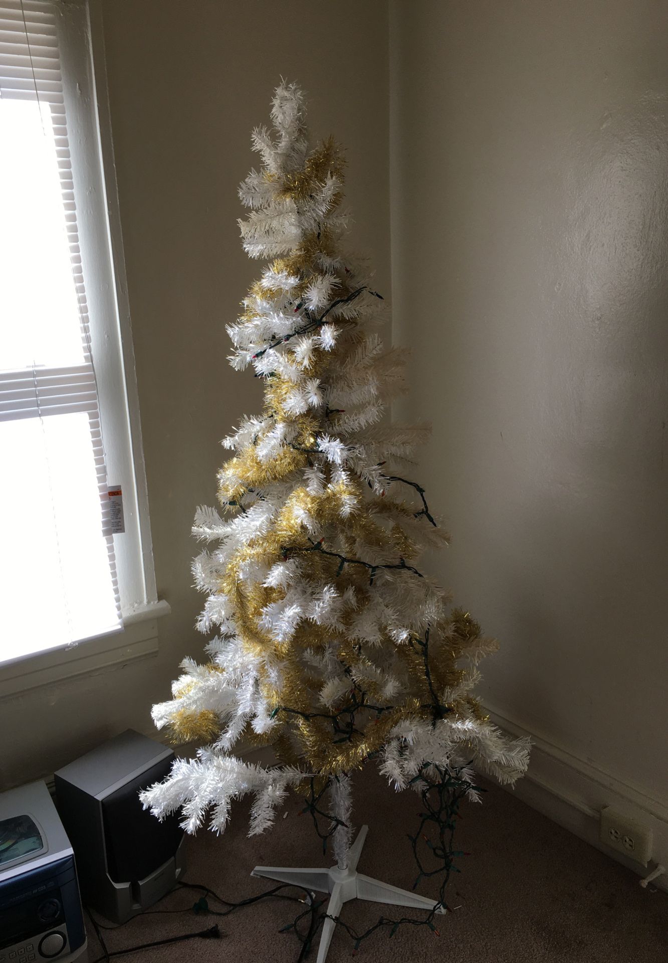 Christmas tree and bag of assorted ornaments